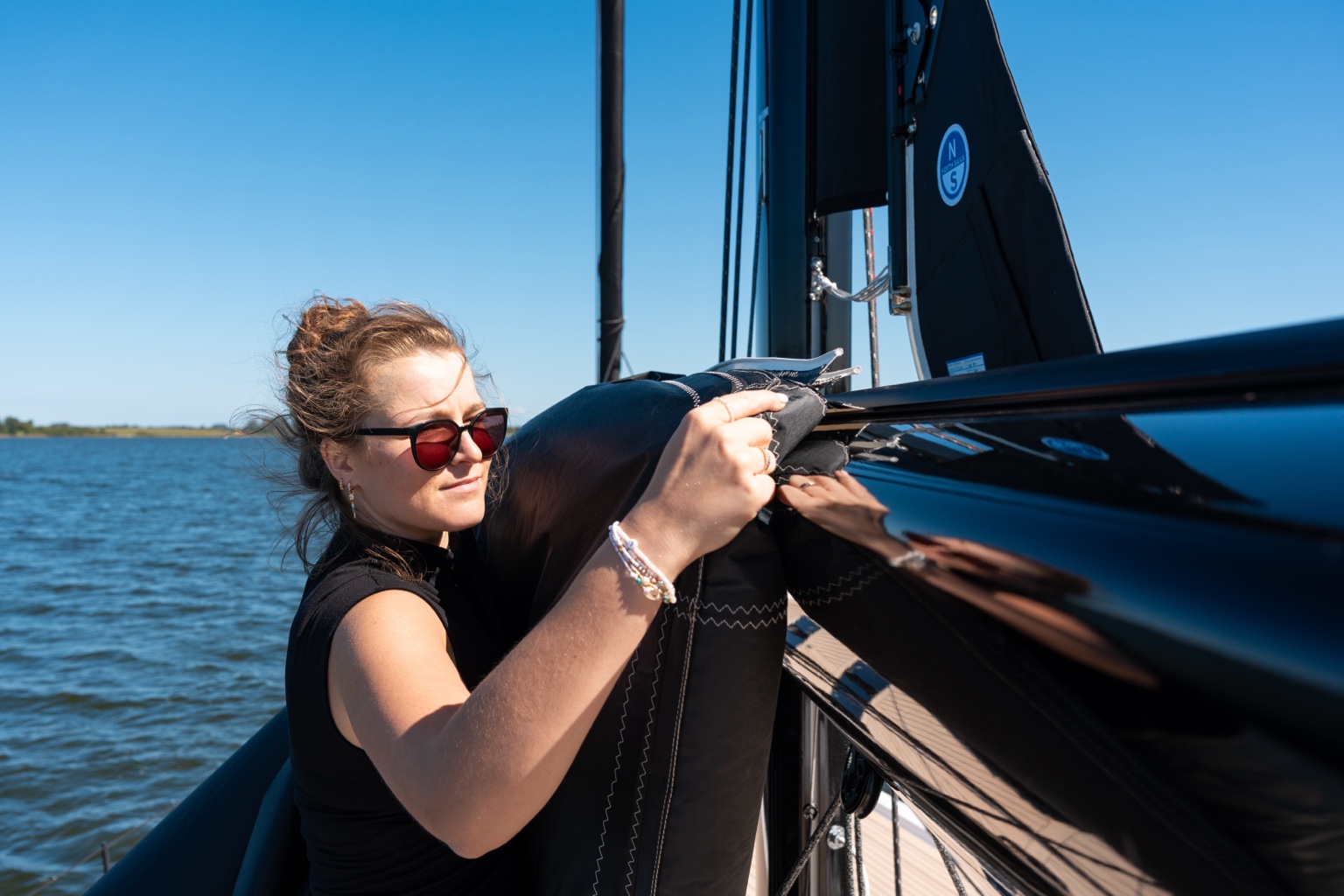 Volamare sun protection being positioned on the yacht’s boom